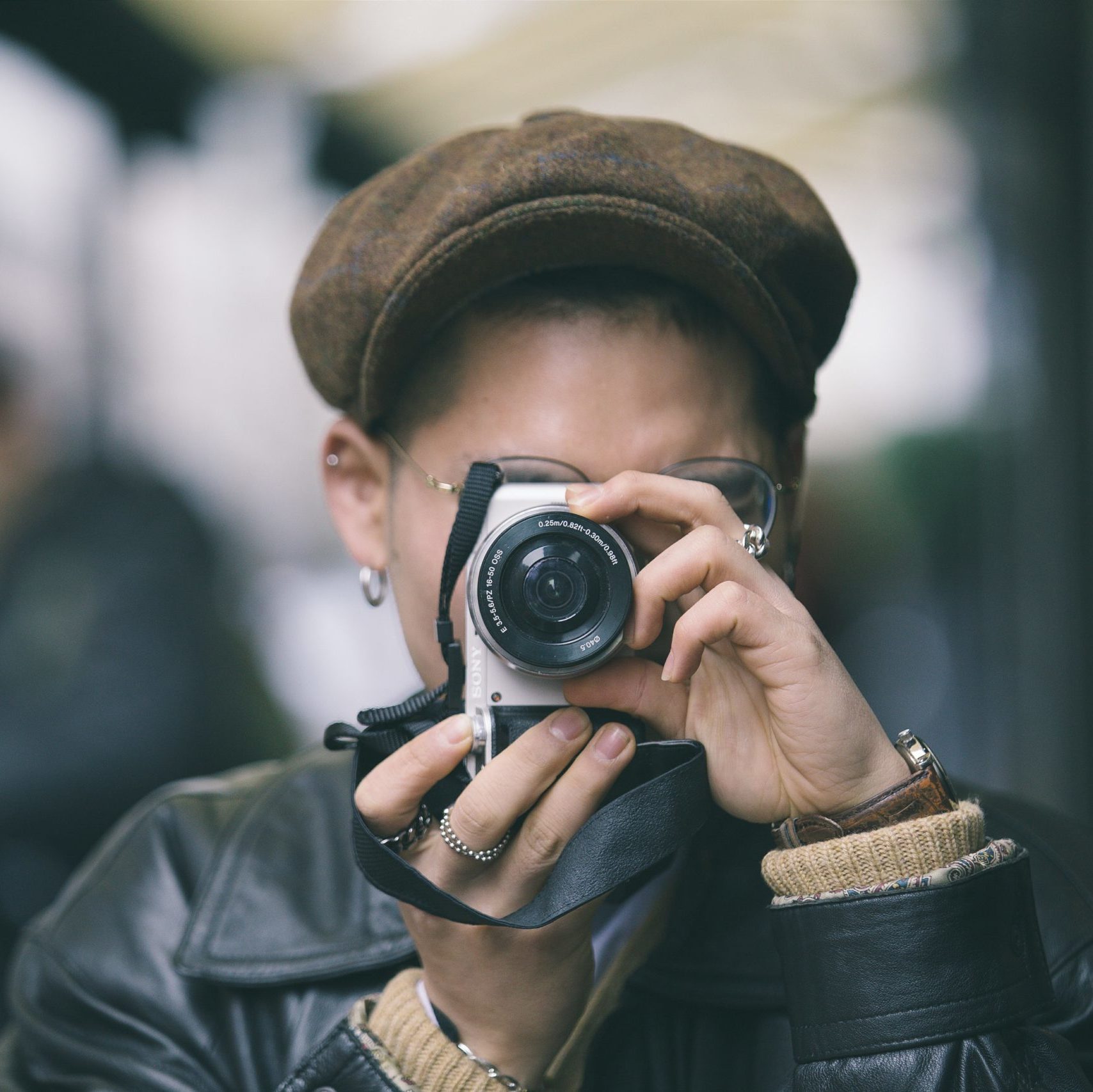 young woman pointing a camera at viewer